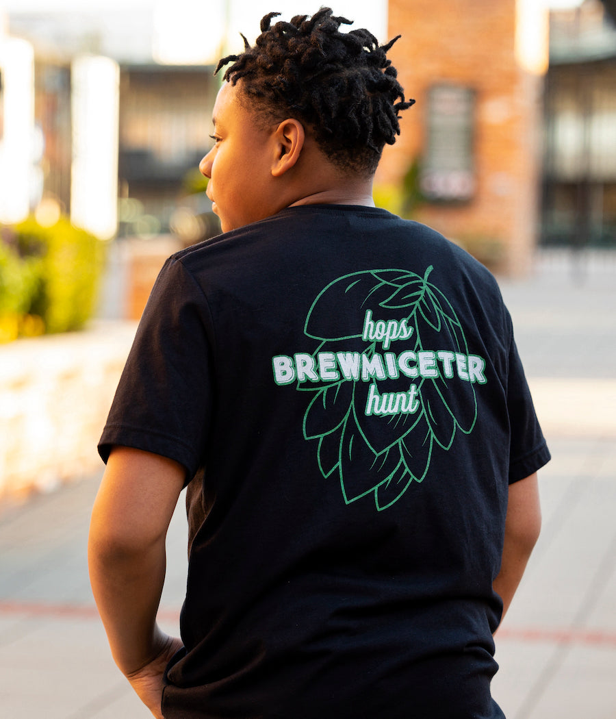 Statement Brewmiceter Hops Hunt design which has our Hops Hunt statement logo on the back in green and white and our hipster mouse done in green to match the back design on the front left chest. 